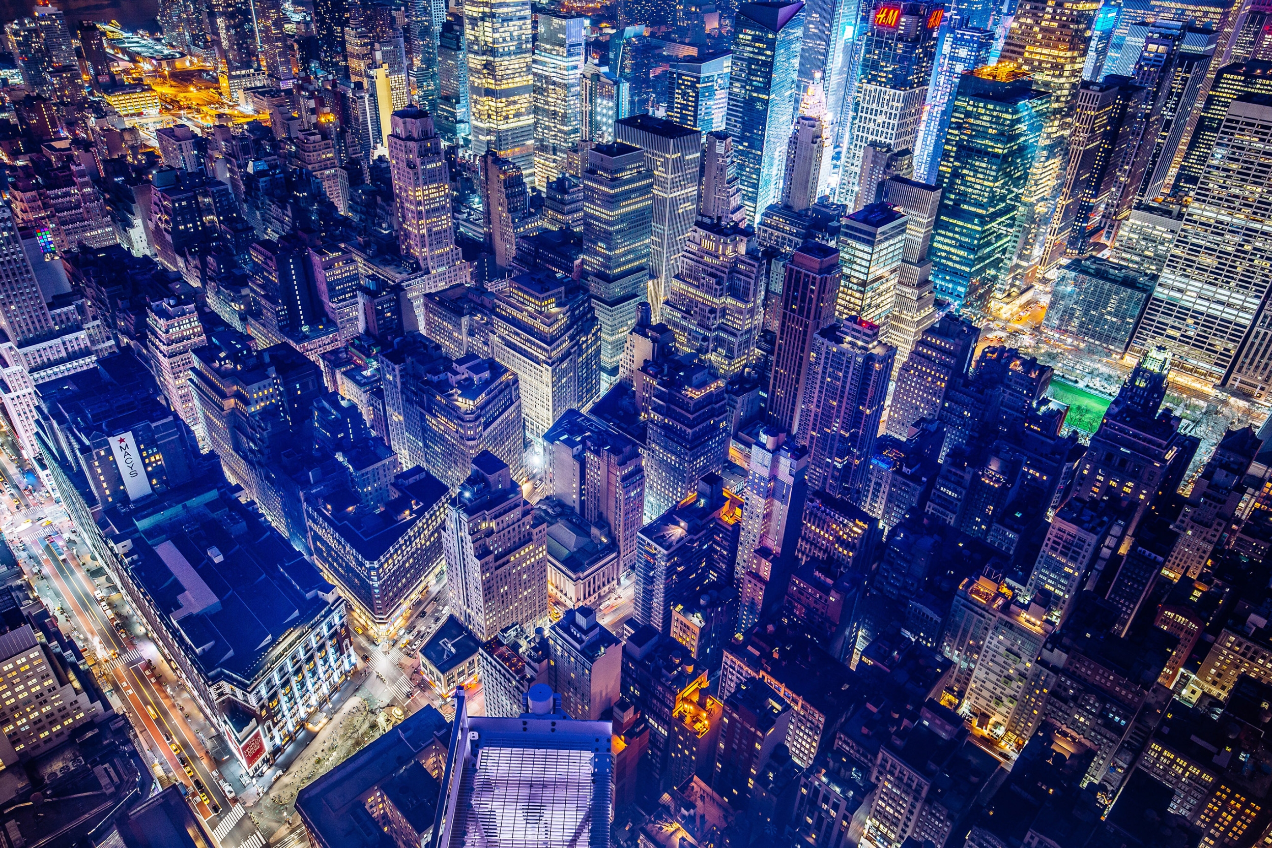 Cityscape at night showing brightly lit buildings.